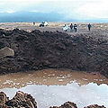 People in southern Peru gaze at a crater
