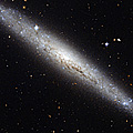 Hubble portrays a dusty spiral galaxy