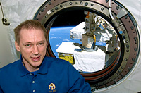 Frank De Winne near a window in the Japanese Kibo laboratory