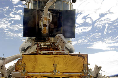 Astronauts at work on Hubble