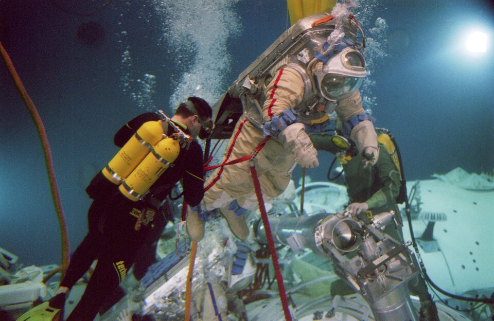 Divers help and monitor the space walk training