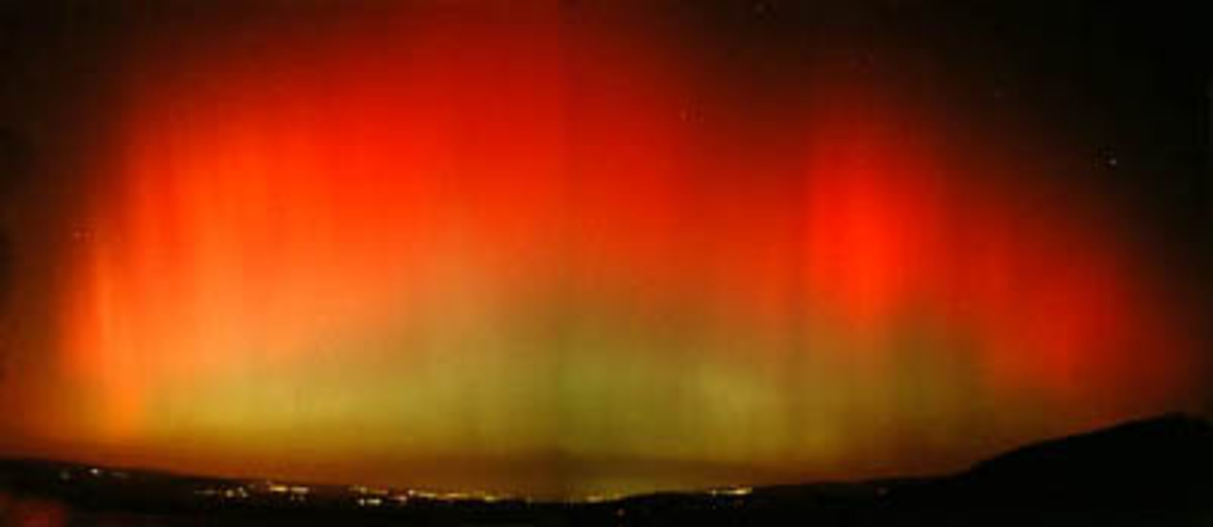 Shimmering curtains of red and green illuminate the long winter nights near the Arctic Circle
