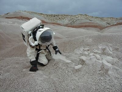 Geologist Andrea Fori observes sedimentary erosional features