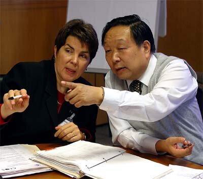 L. Moodie of US NOAA (l) with D. Li of China's Ministry of Science and Technology