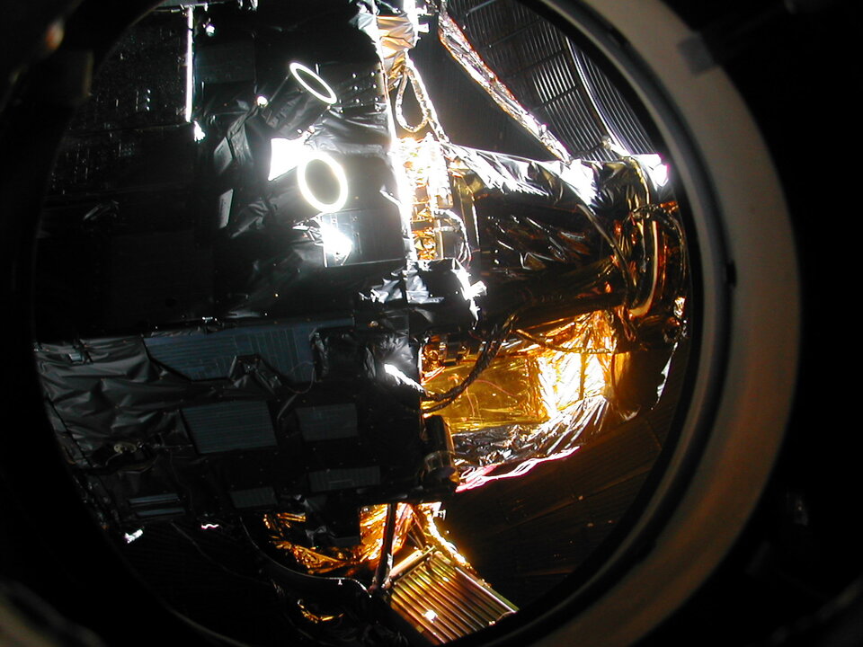 The satellite in the vacuum chamber with simulated Sun illumination