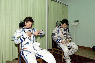 Gennady Padalka and Pedro Duque are donning their Sokol pressure suits - Star City