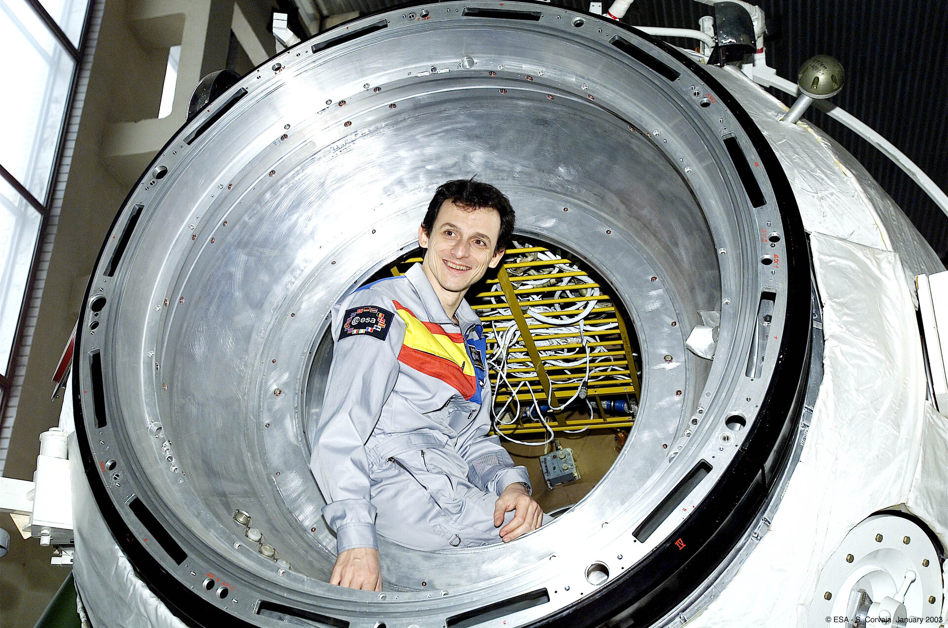 Pedro Duque sits at entrance of the Soyuz simulator at Star City