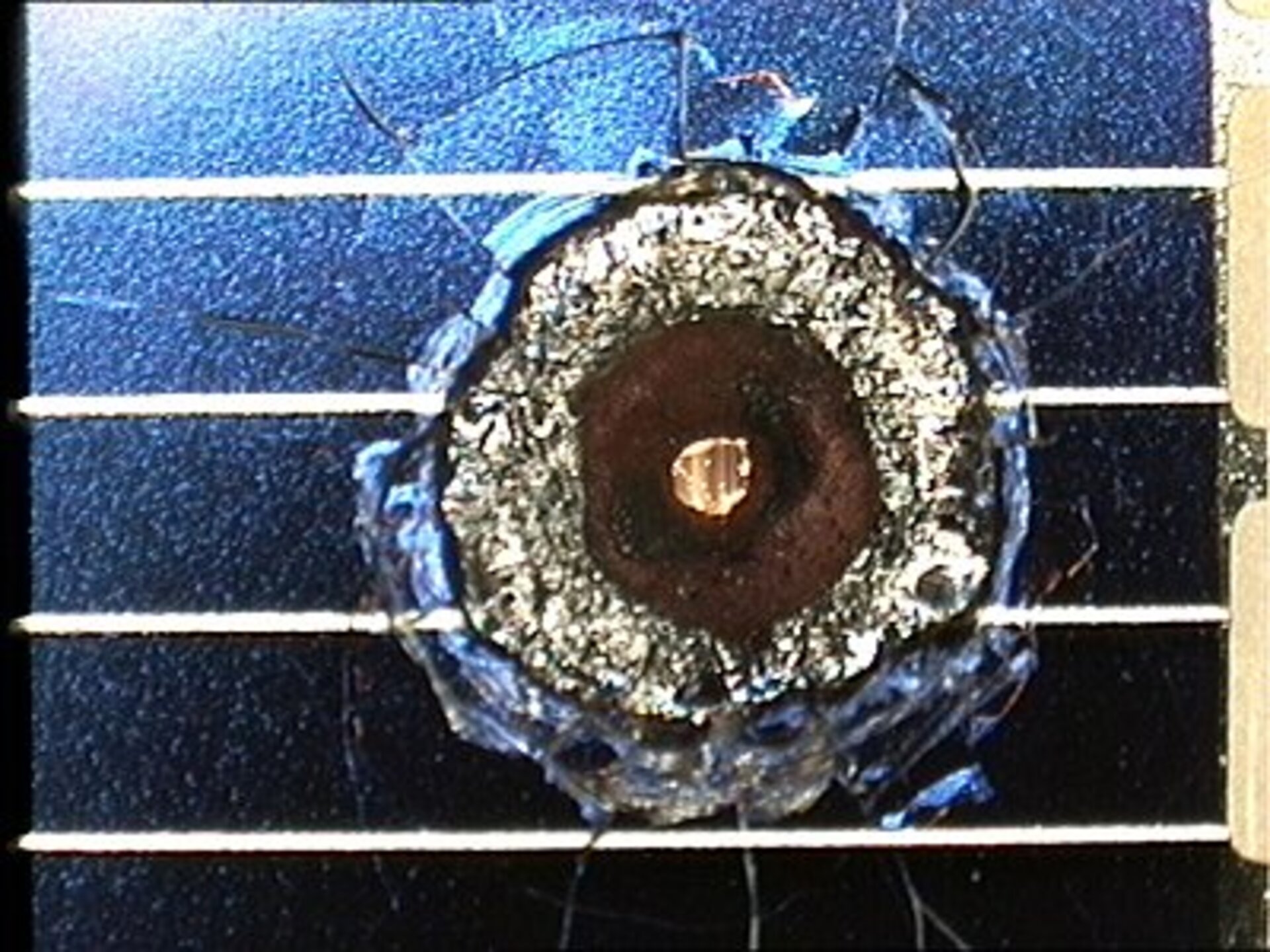 Impact crater (size 4 mm) on solar cell retrieved from space