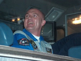 A smiling André Kuipers on the bus after leaving the Kosmonavt Hotel in Baikonour