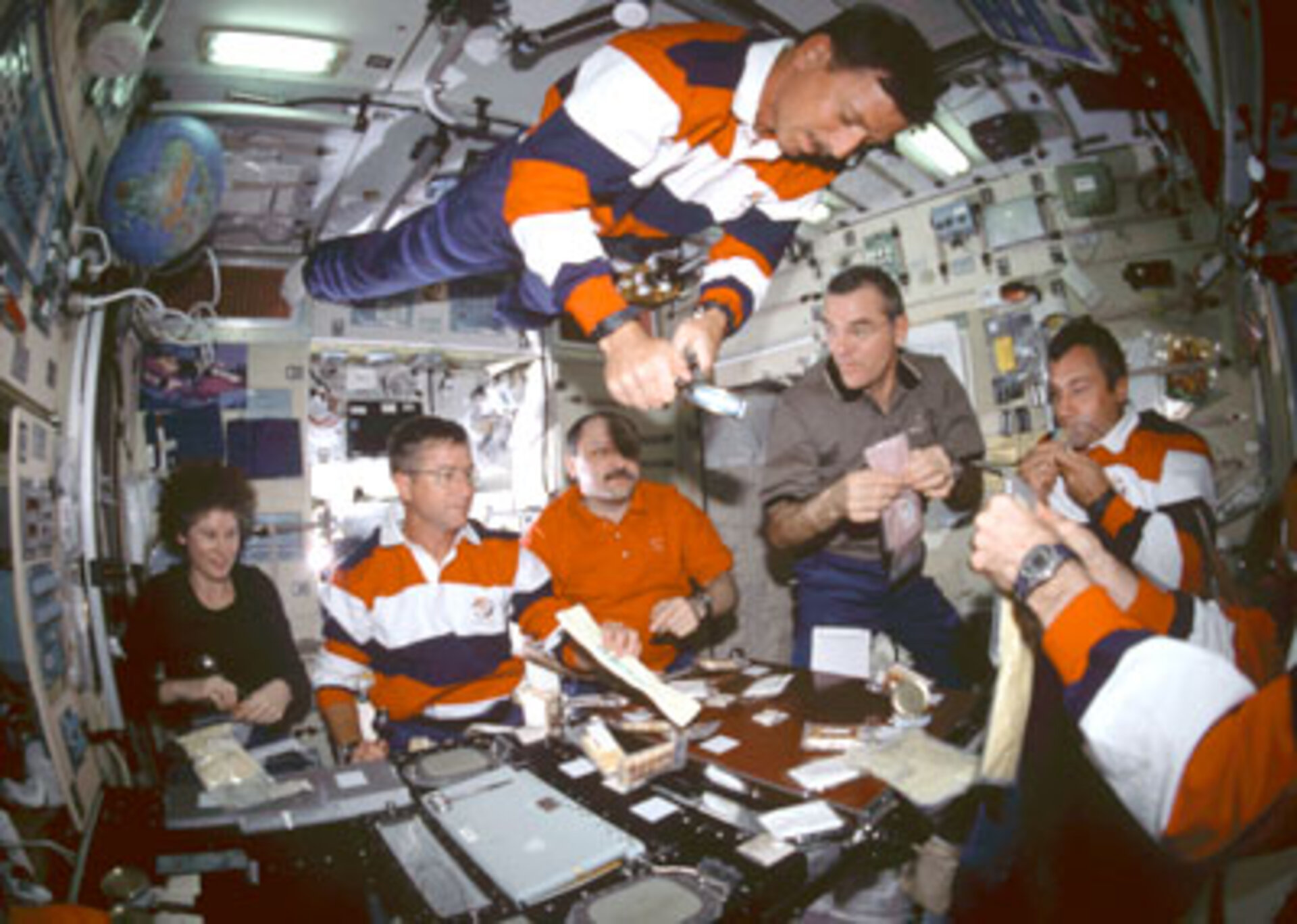 Astronauts share a meal
