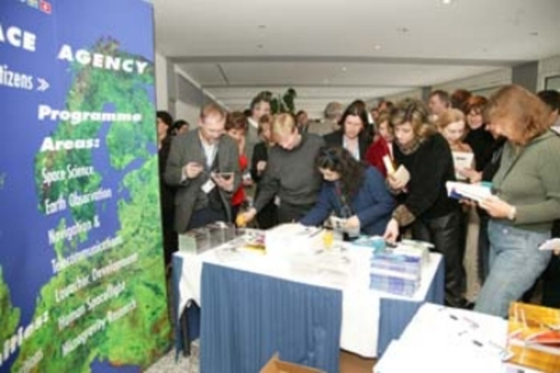 Attendees gather at information table