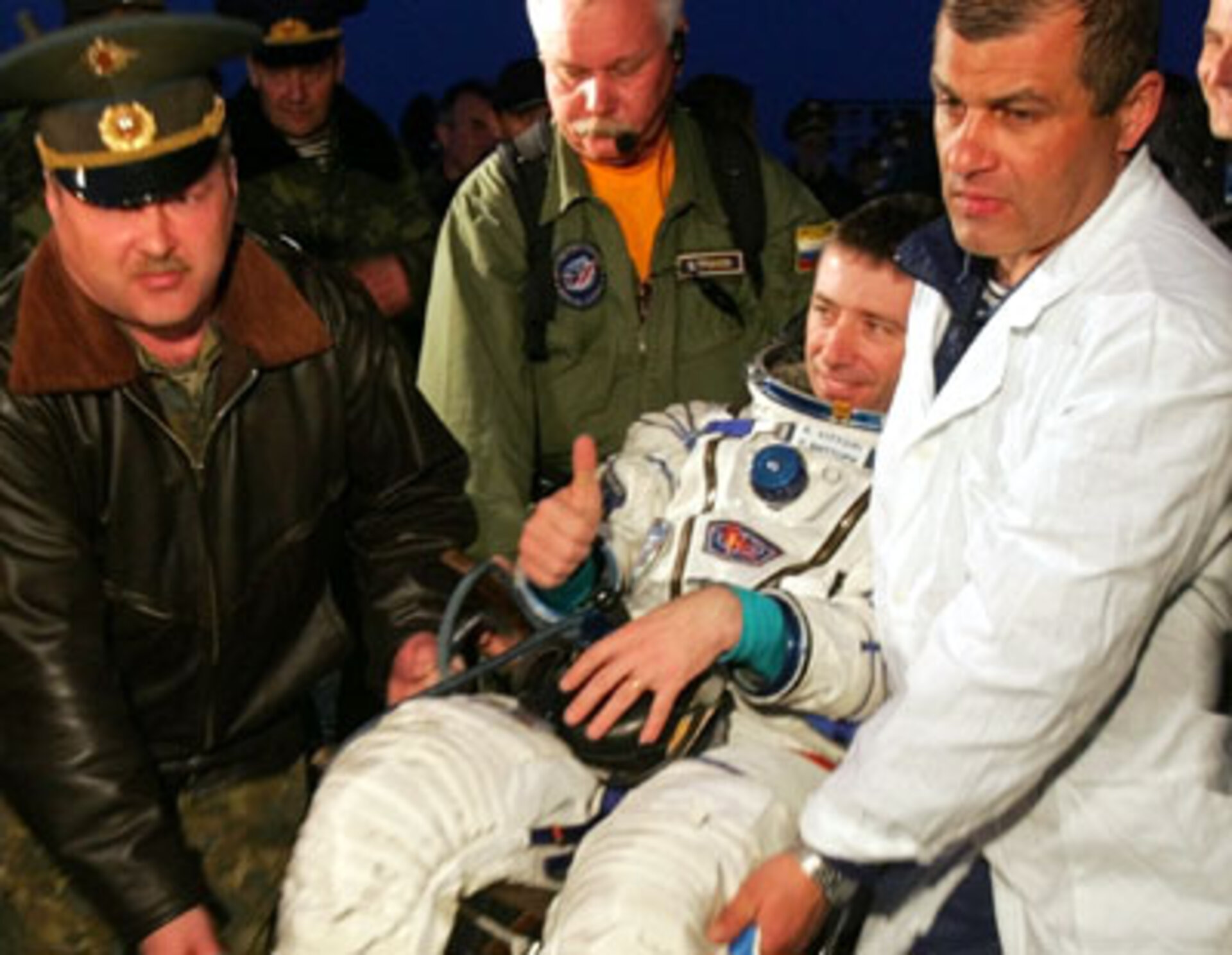 Roberto Vittori is helped out of the Soyuz TMA-5 capsule shortly after landing