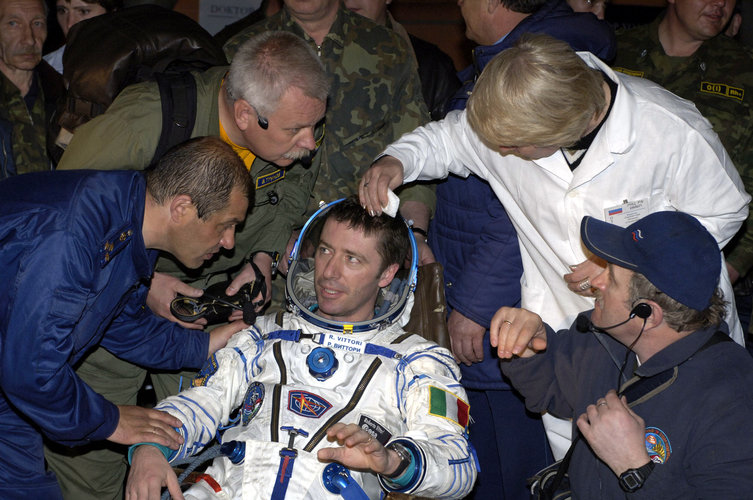 Roberto Vittori is helped out of the Soyuz TMA-5 capsule shortly after landing