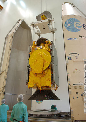 The HOT BIRD 7A satellite and its payload adapter are removed from a transport container