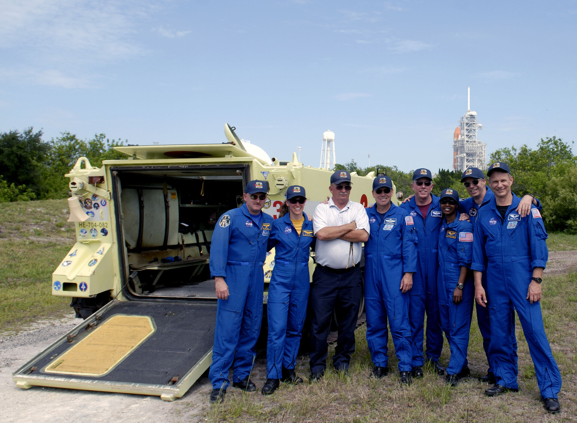 The STS-121 crew with astronaut rescue team leader Capt. George Hoggard after training with the M-113 armoured personel carrier