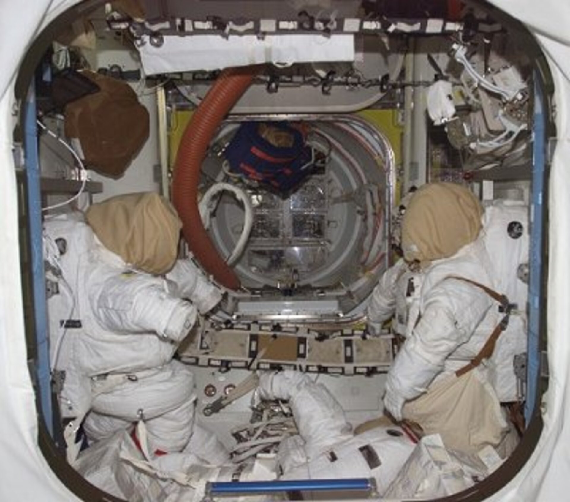 A view of the Quest Joint Airlock - the US EVA spacesuits, like those to be worn by Reiter and Williams on 3 August, are seen to the left and right