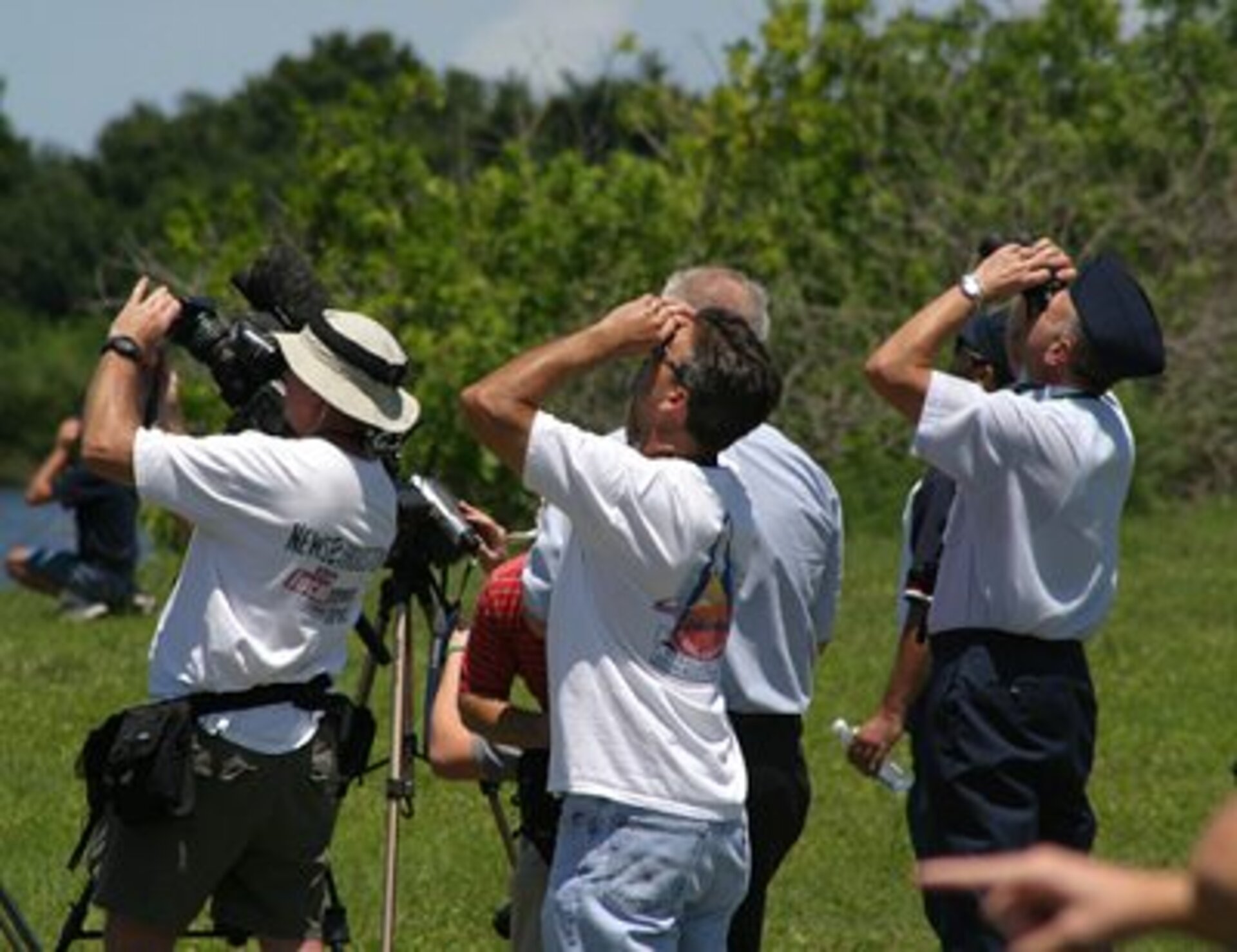 Spectators and press look to the skies as Discovery races off the launch pad