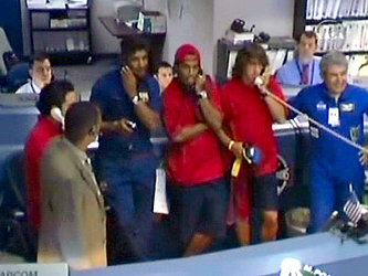 FC Barcelona coach Rijkaard and players Xavi, Puyol and Ronaldinho, make a phone call to the ISS Expedition 13 crew