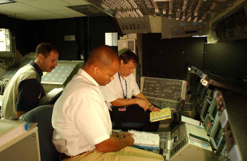 The Space Shuttle cockpit simulator, occupied here by Robert Curbeam  and Christer Fuglesang