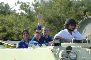 The STS-116 crew practice driving an emergency evacuation vehicle