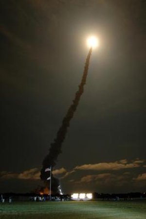 Discovery lights up the night sky over Florida