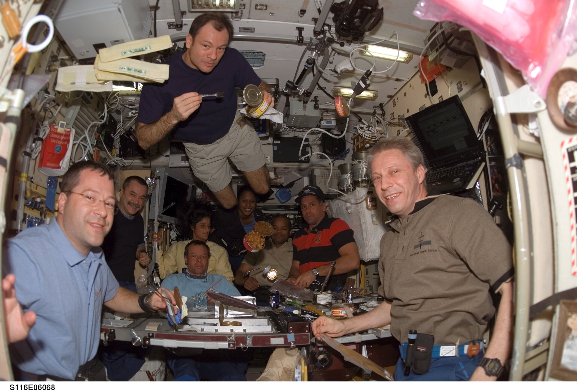Shuttle and Station crews dining together in the Zvezda Module