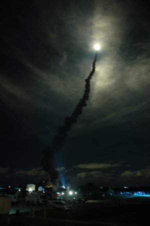 Space Shuttle Discovery streaks through the clouds after liftoff from Launch Pad 39B on mission STS-116