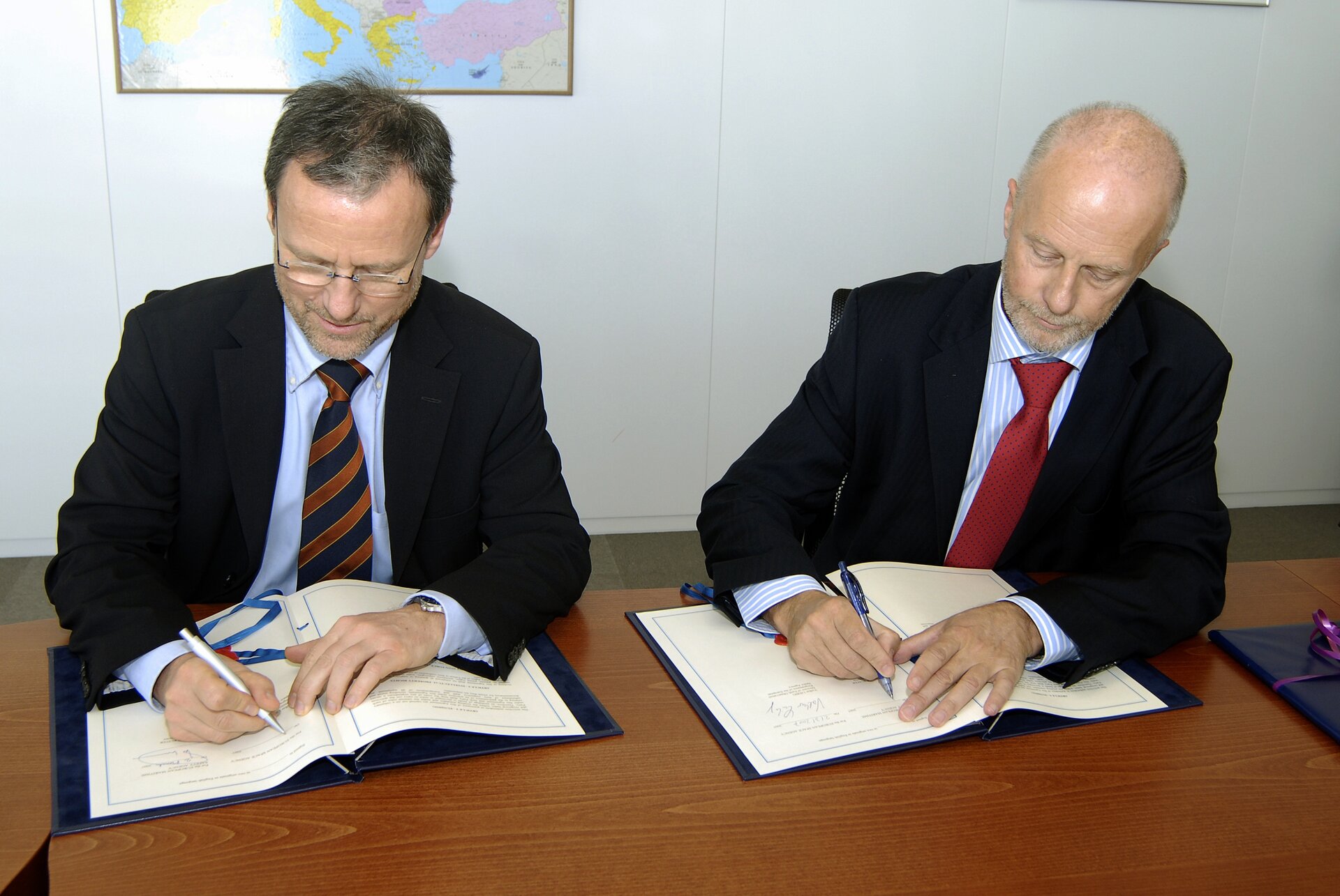 Volker Liebig (links) und Willem de Ruiter (rechts) unterschreiben die Vereinbarung in Lissabon