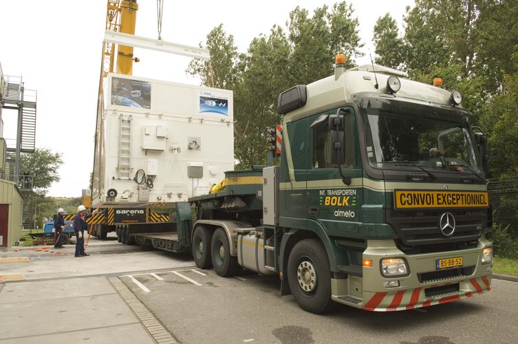 ATV transportation containers are loaded onto trucks outside the ESTEC Test Centre