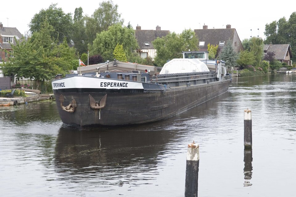 Canal barge carrying ATV's Integrated Cargo Carrier passes through Leiden