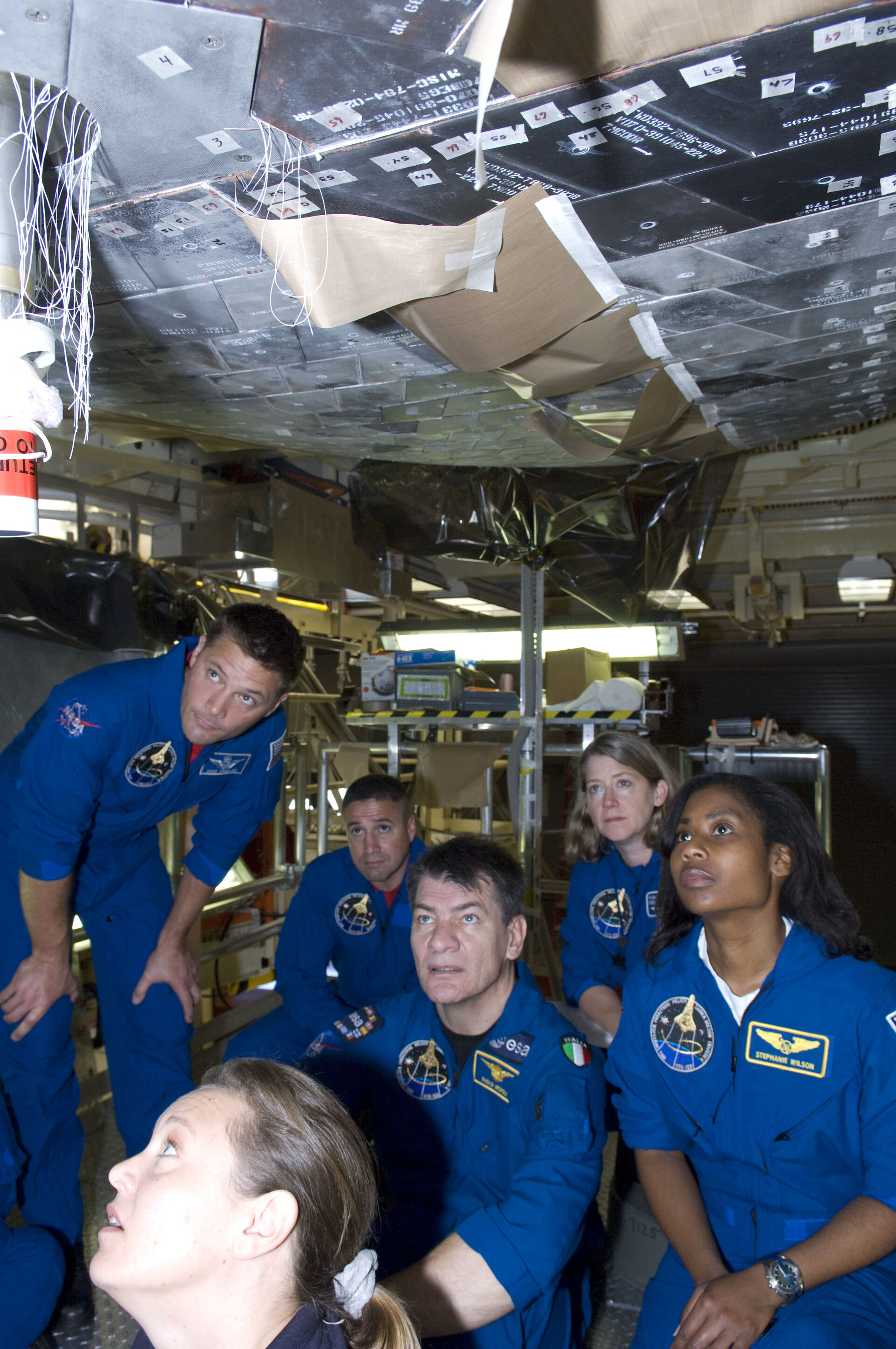 STS-120 crew inspect Discovery's tiles during CEIT at Kennedy Space Center, Florida