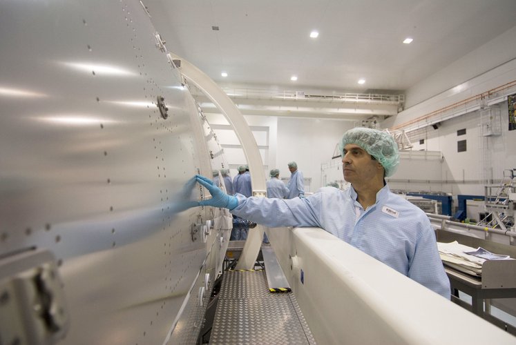 ESA astronaut Leopold Eyharts inspects the outside of the European Columbus laboratory