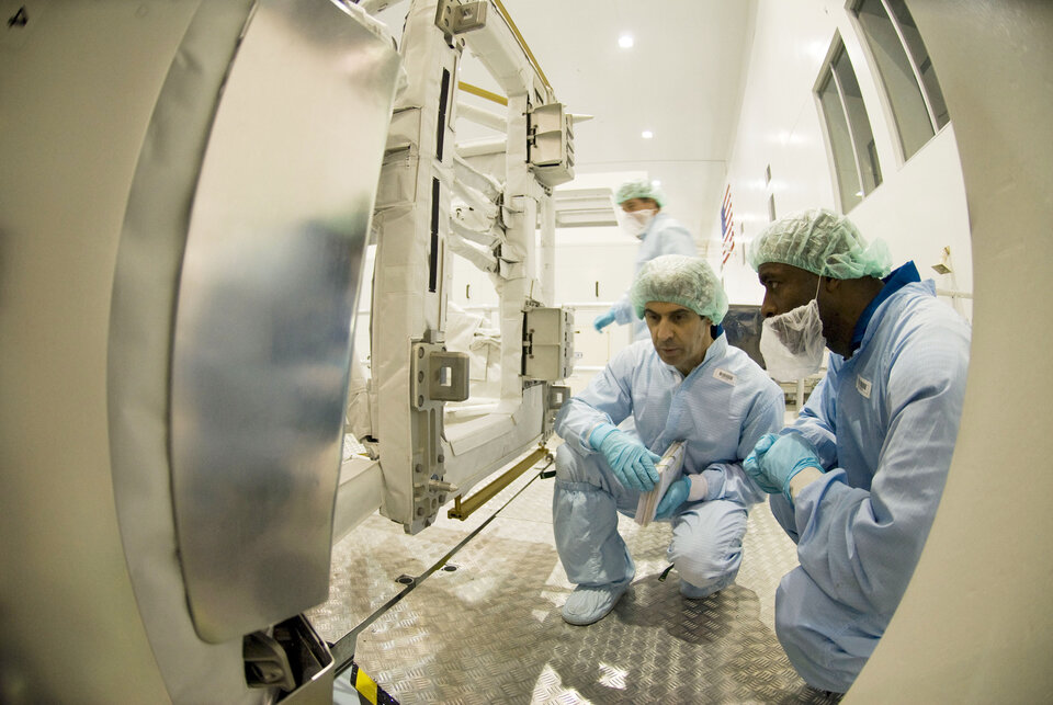 Leopold Eyharts and Leland Melvin inspect the European Columbus laboratory