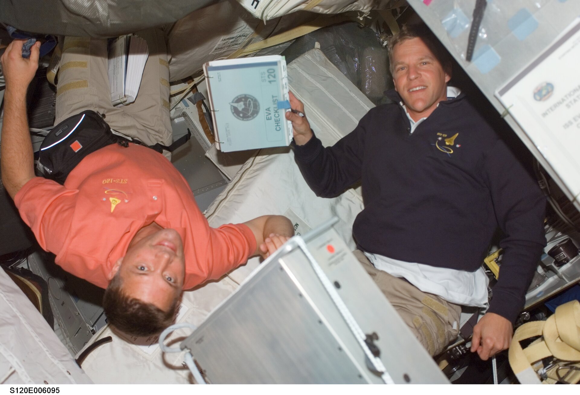 Scott Parazynski and Douglas Wheelock prepare for the first spacewalk