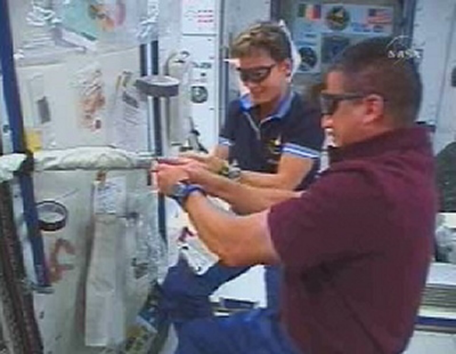 Astronauts prepare tools for use during the spacewalk