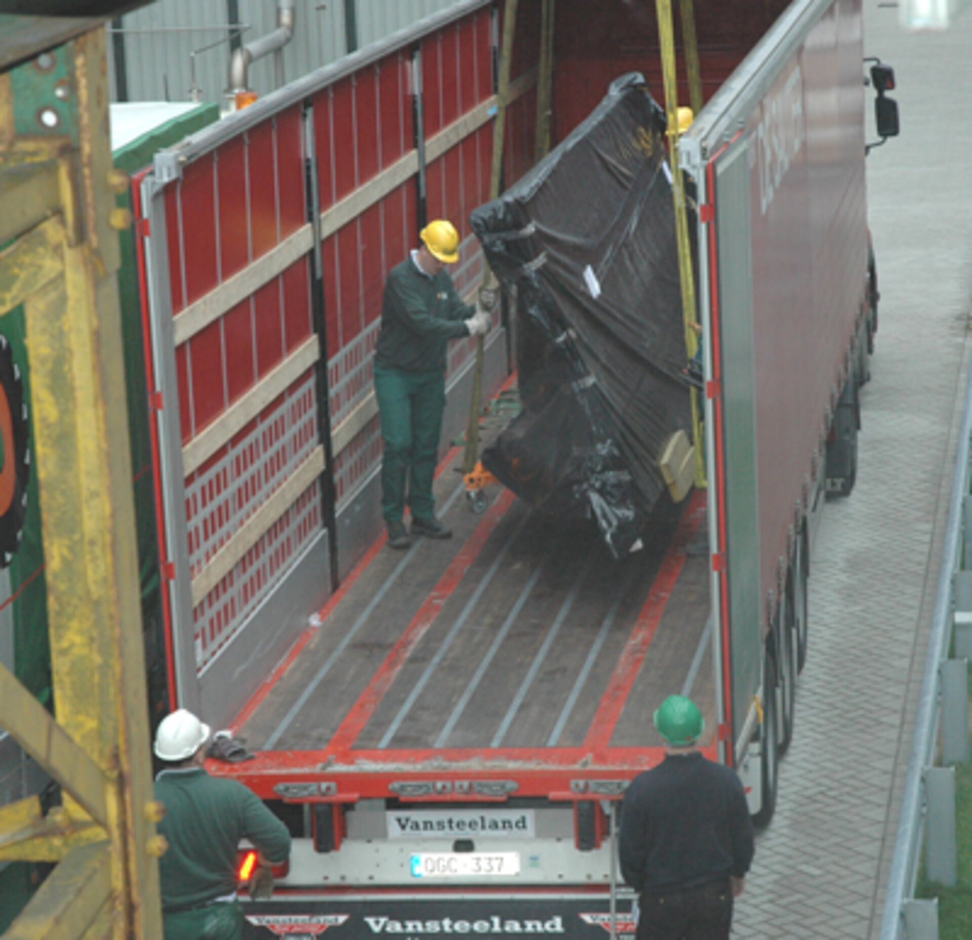 The glass screen is unloaded from its delivery truck