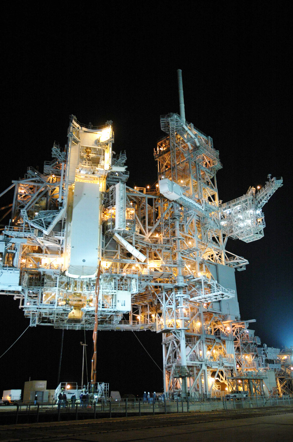 Payload canister (white rectangular box to left of centre) holding Columbus is lifted into place at the launch pad