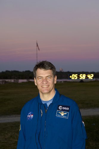 Paolo Nespoli stands in front of the launch countdown clock at KSC