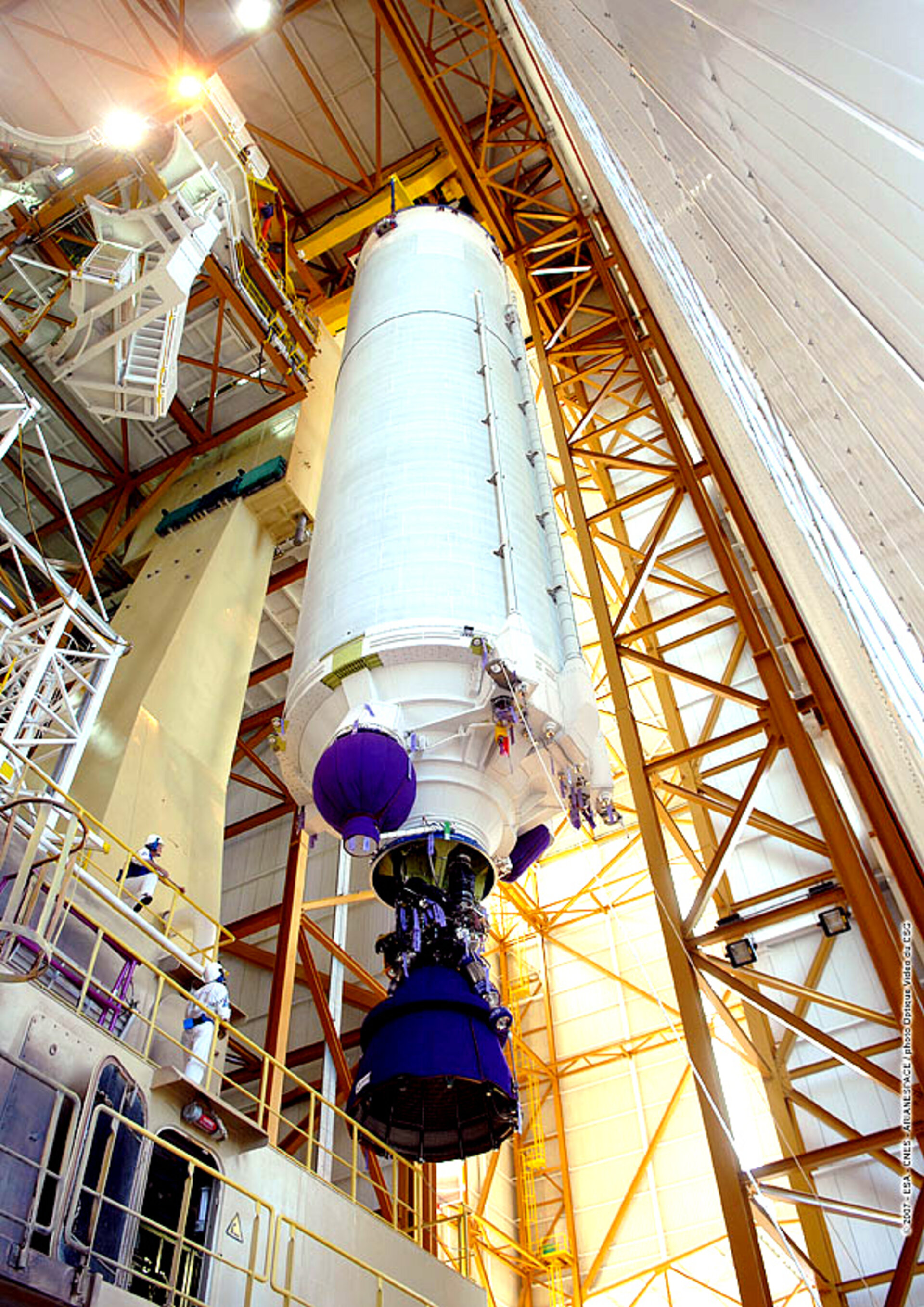 The main cryogenic stage for Jules Verne's Ariane 5 ES launch vehicle is hoisted into vertical position