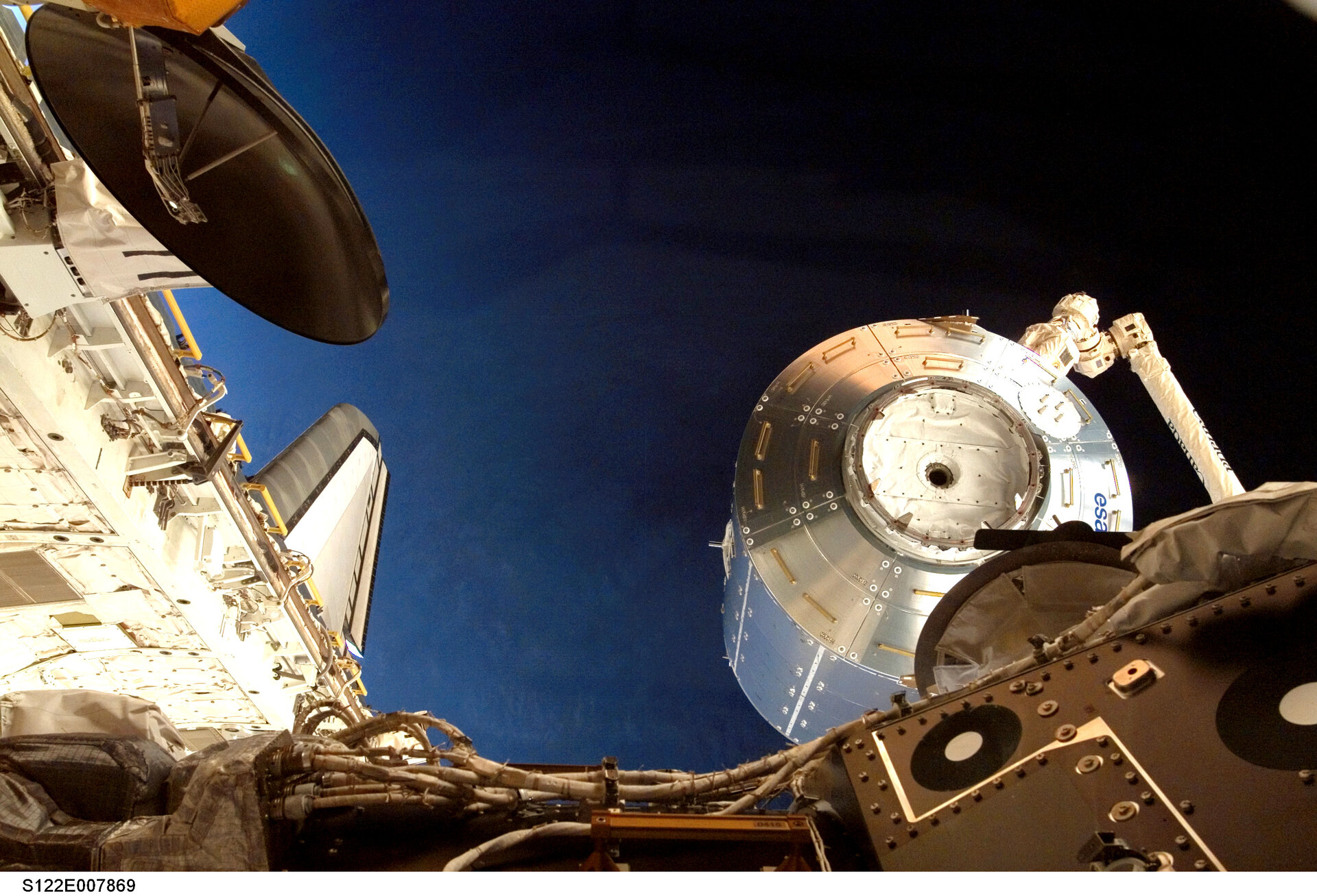 Columbus is lifted out of Atlantis' payload bay ready for installation on the International Space Station