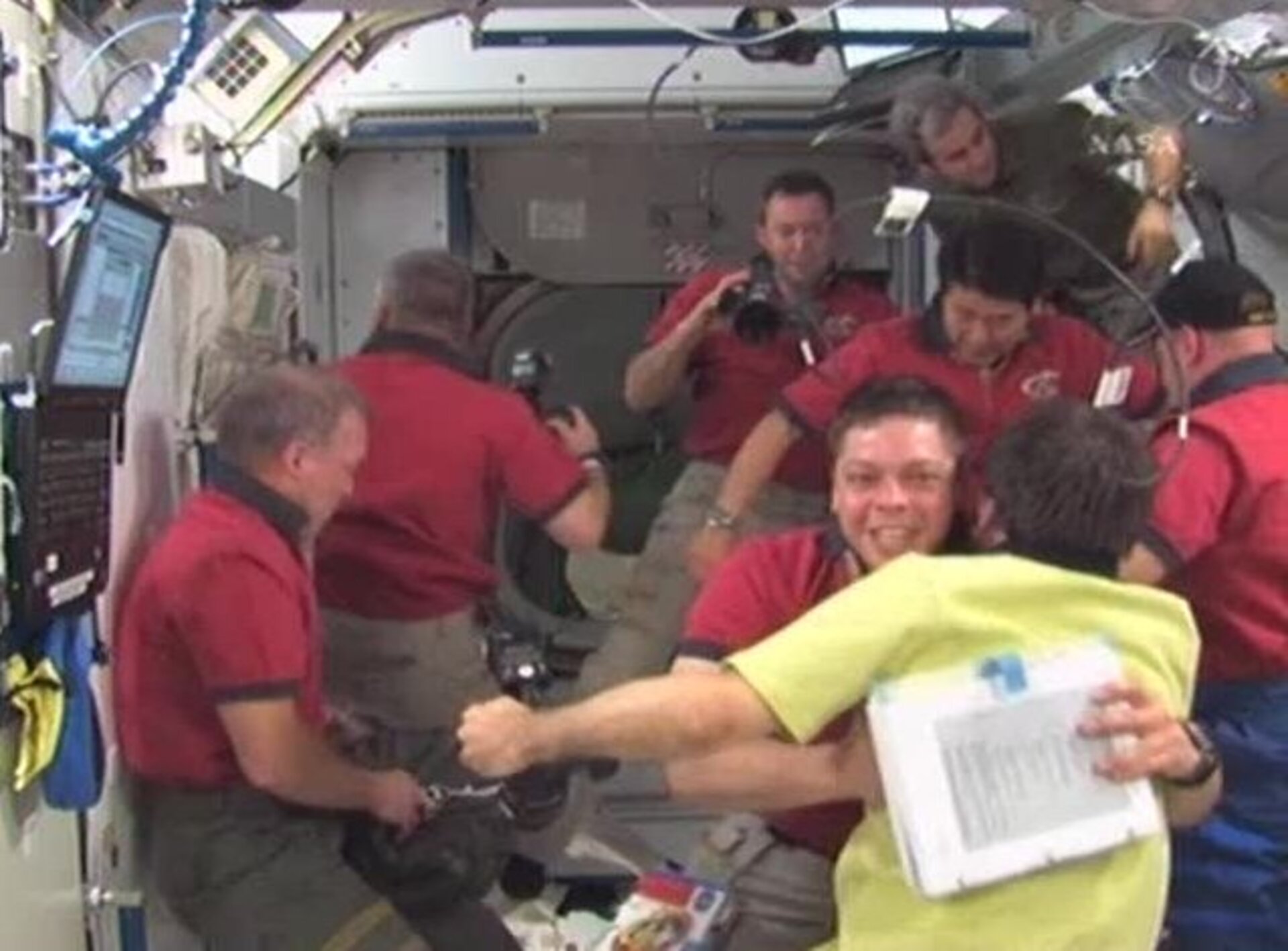 STS-123 crew are welcomed on board ISS after hatch opening