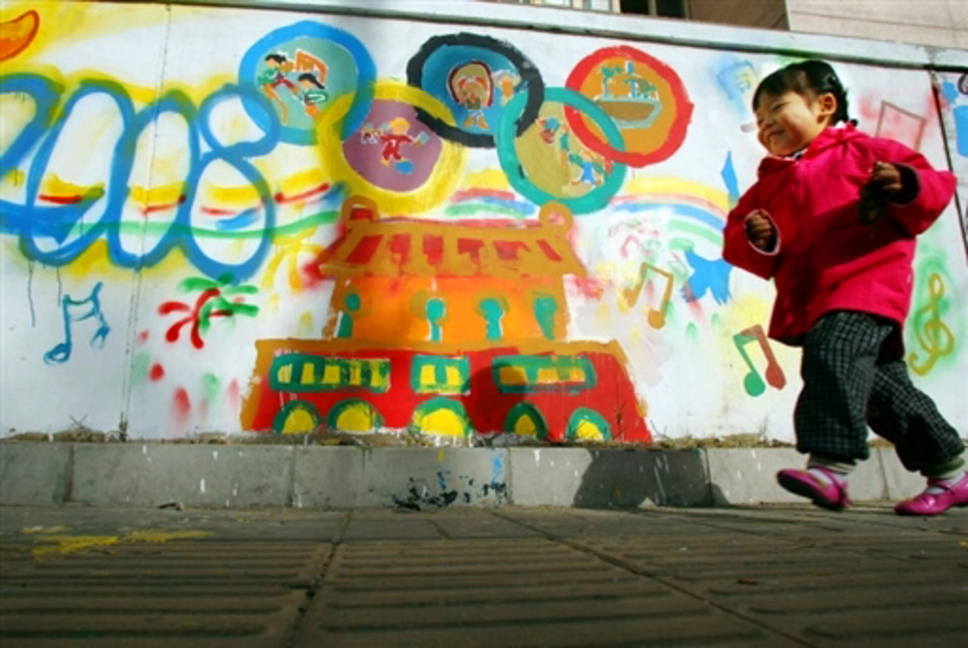 A young Chinese girl plays outside her home
