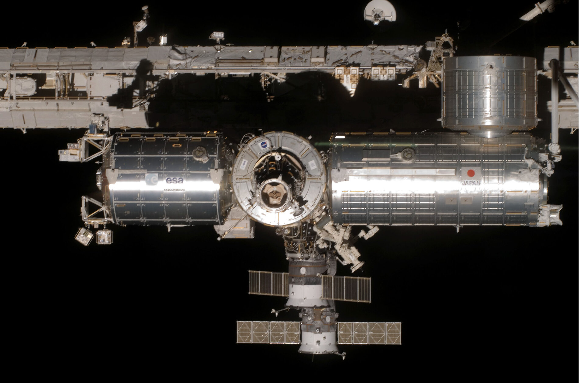 ESA's Columbus laboratory, Node-2 and Japan's Kibo module at the ISS (main truss at rear, two Soyuz vehicles lower centre)