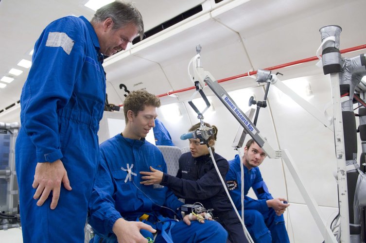 Experiment subjects also fly on the 'Zero G' aircraft - here they are briefed before the flight