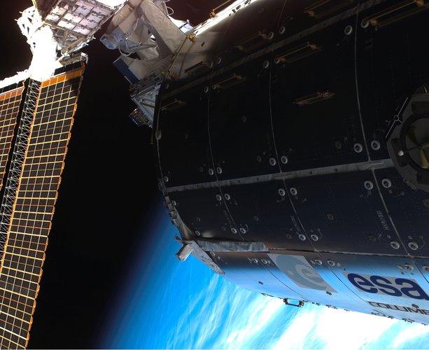 External view of ESA's Columbus laboratory on the ISS, part of ISS solar panel visible