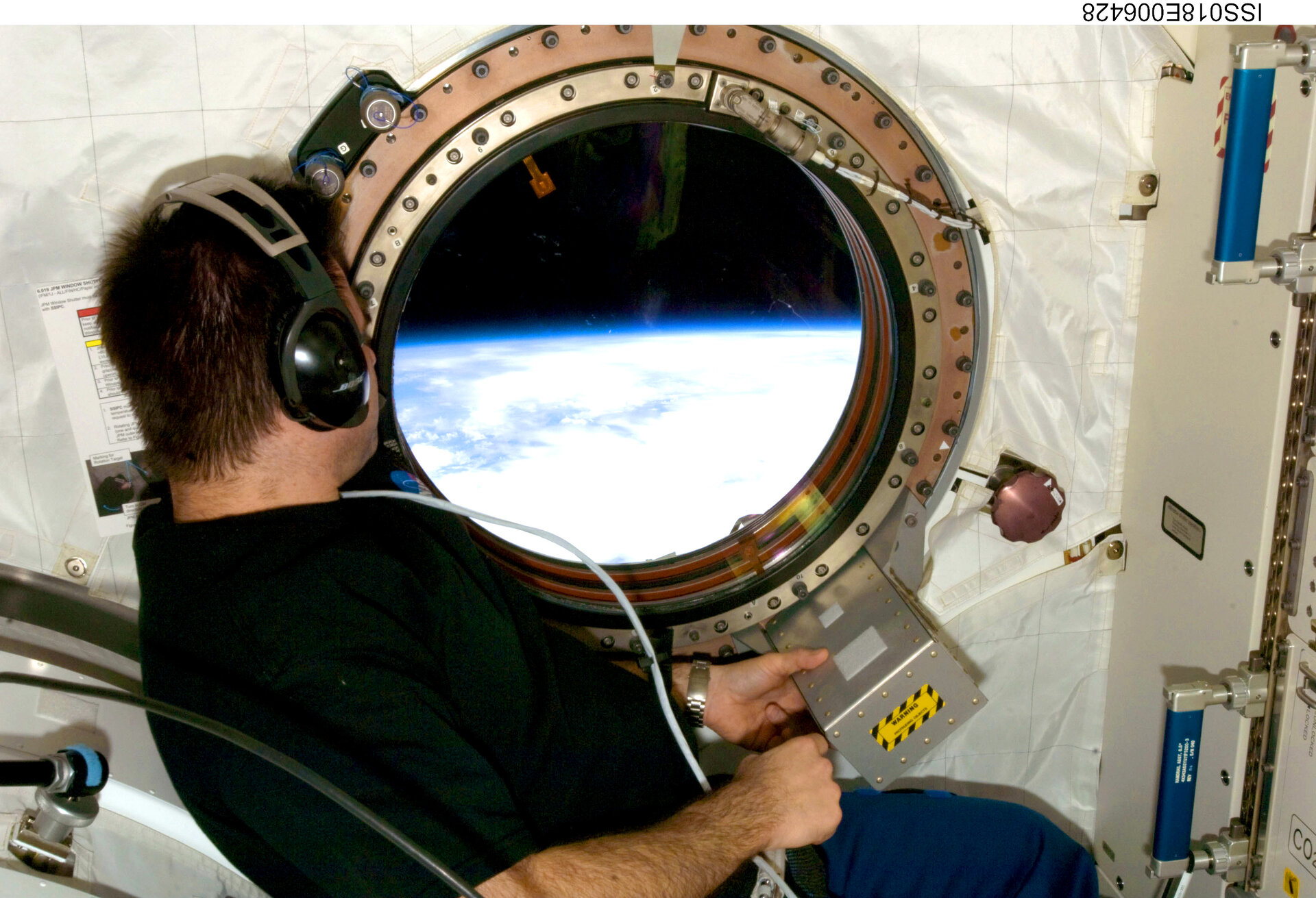 Looking through the window in the Kibo laboratory of the ISS