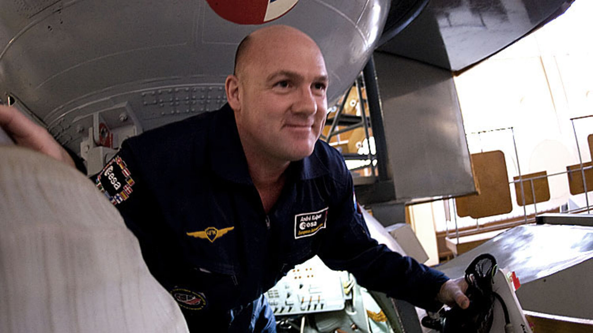 André Kuipers climbs out of the Soyuz simulator at Star City