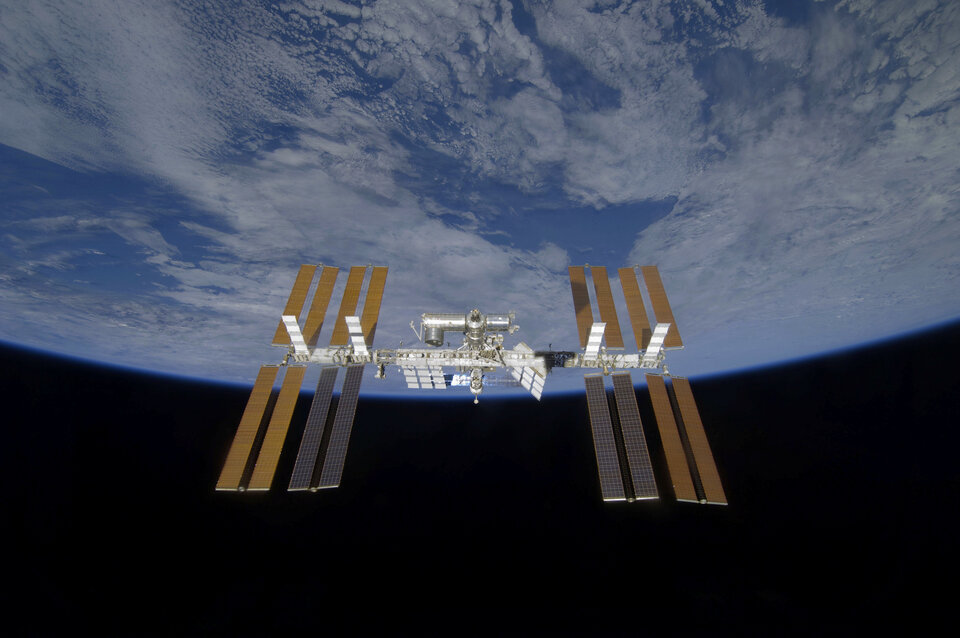 A view of the International Space Station with all four solar arrays now deployed
