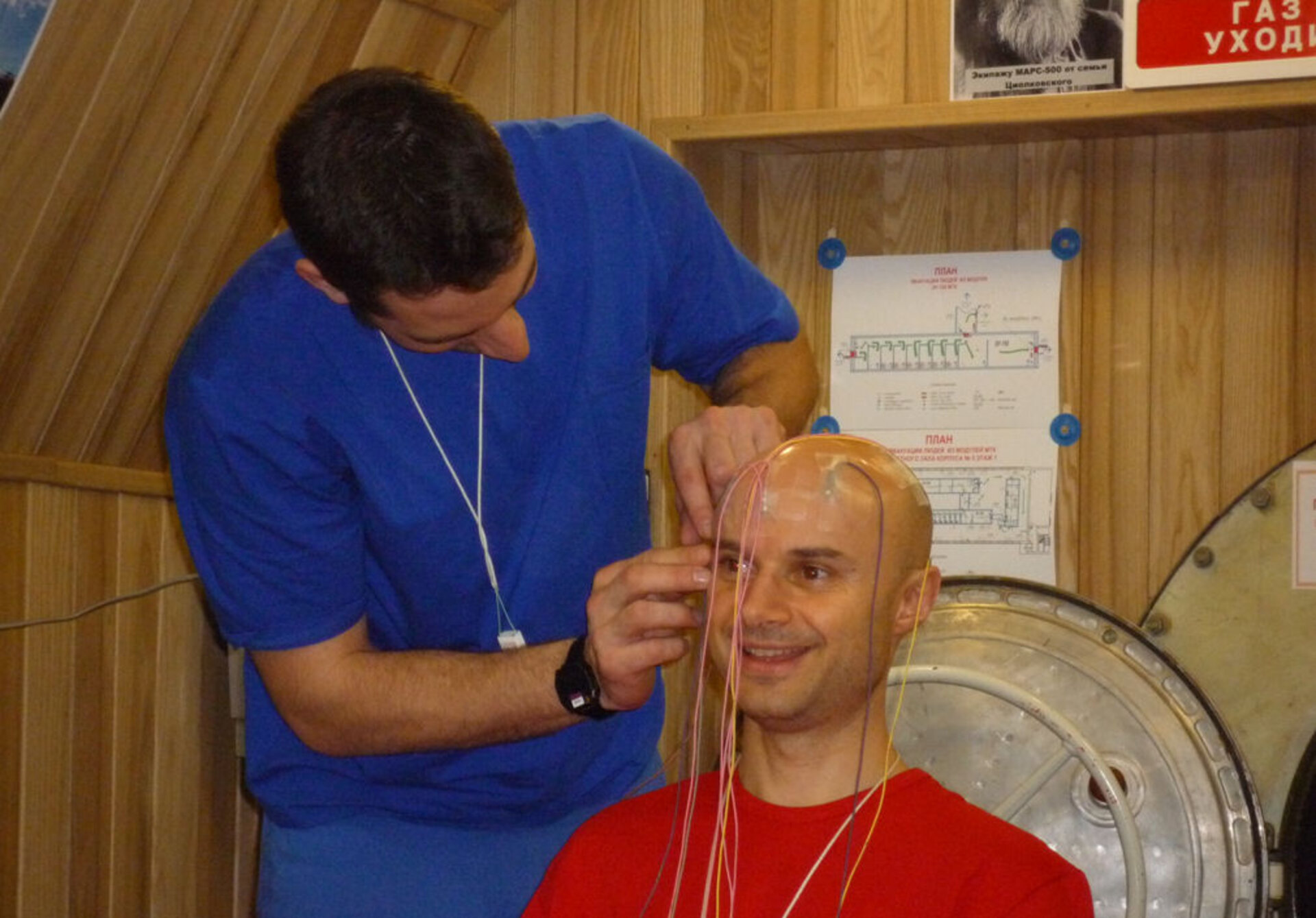 Oliver sets up Cyrille's EEG for a night recording