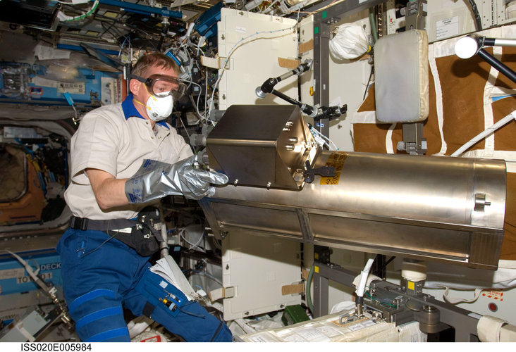 Frank De Winne works with the Water Recovery System Recycle Filter Tank Assembly